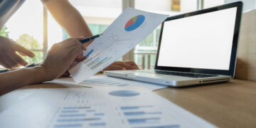 Asia business people discussing the charts and graphs showing the results of their successful teamwork.Vintage tone Retro filter effect,soft focus,low light.(selective focus)